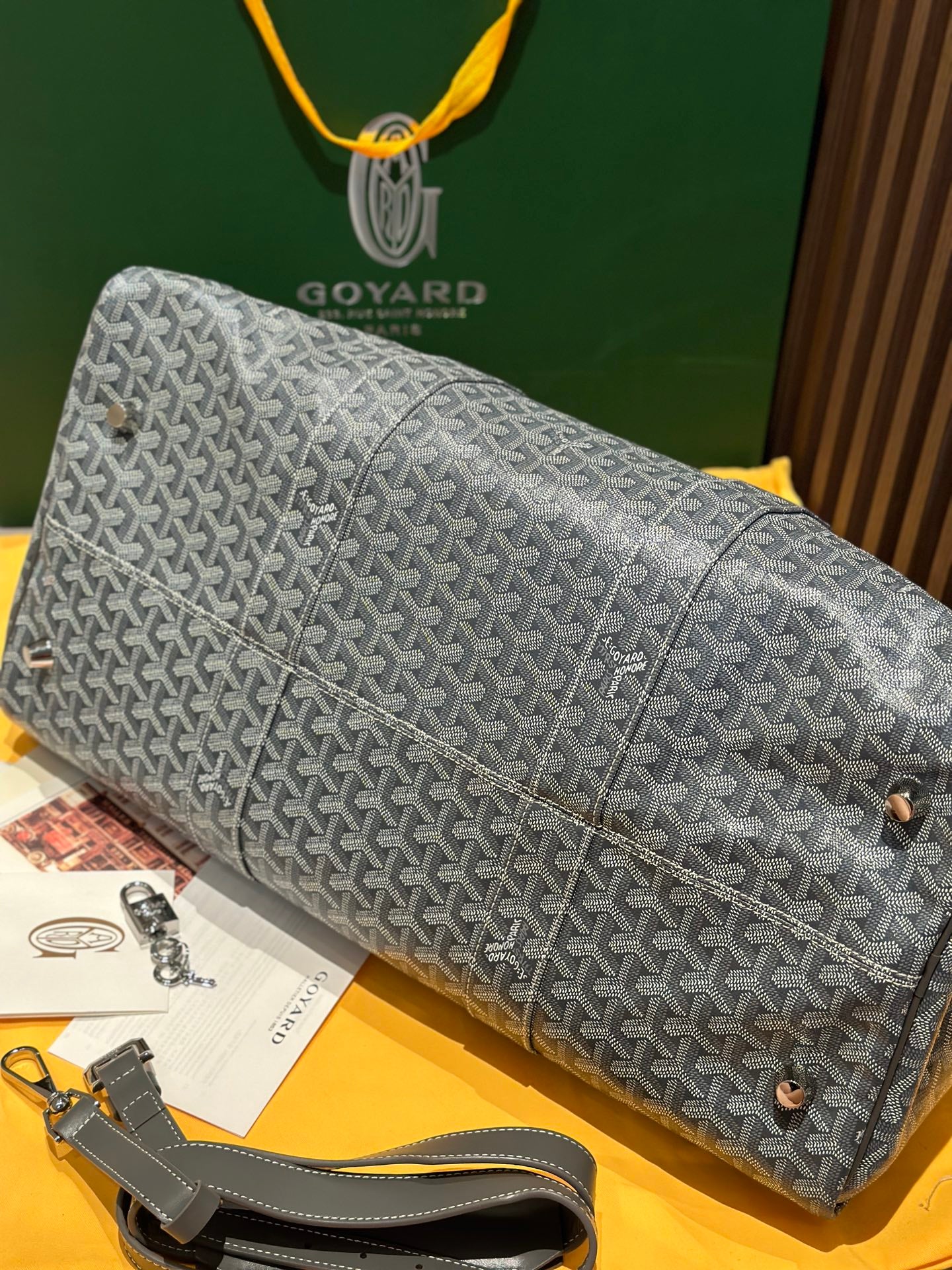 Grey patterned large duffel bag with zip top and detachable shoulder strap