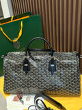 Goyard patterned travel bag with black top handles and side leather trim