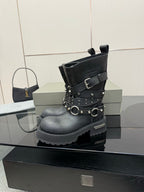 Black studded ankle boot with buckle straps and metal rings, side view