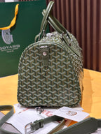 Goyard duffel bag with sage-green Goyardine pattern, rounded handles, and front zipper pocket