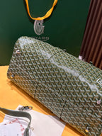 Goyard duffel bag laid flat in sage-green Goyardine with silver zipper and strap accents