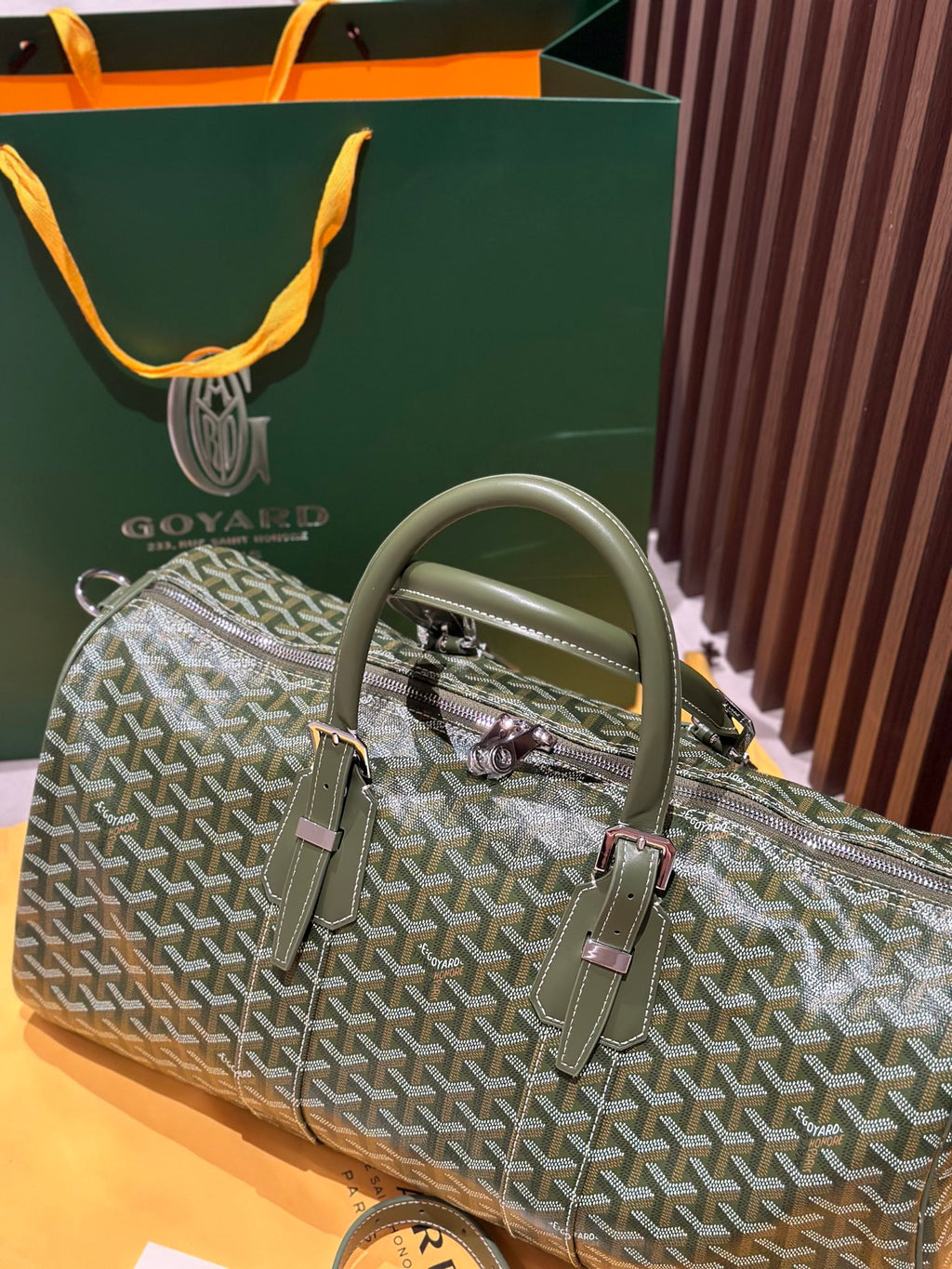 Goyard duffel bag in sage-green Goyardine with rolled handles and two front strap details