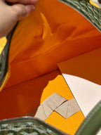 Duffel bag interior with orange lining and stitched seam along the zipper opening