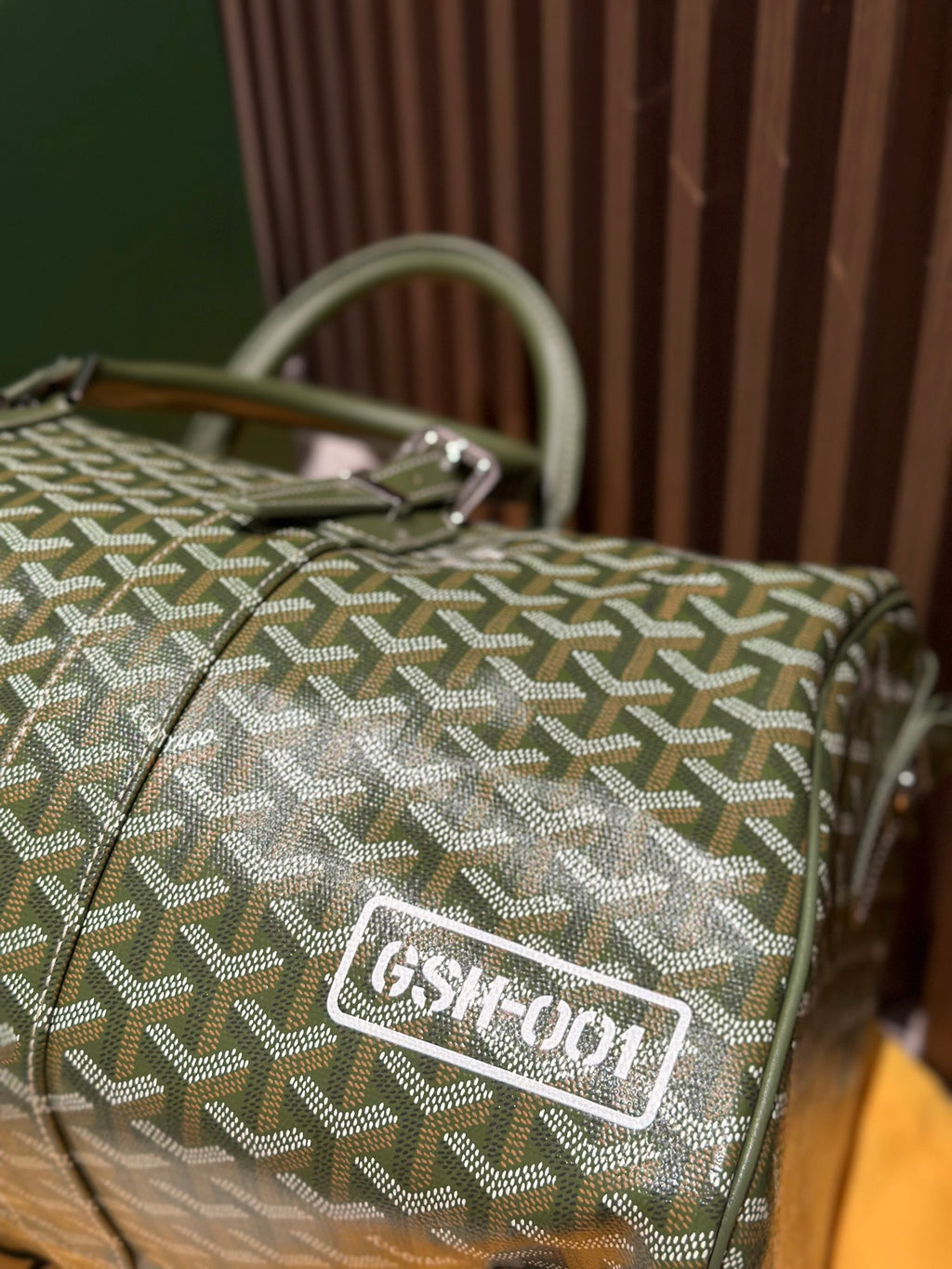 Goyard duffel bag with sage-green Goyardine pattern and engraved logo patch