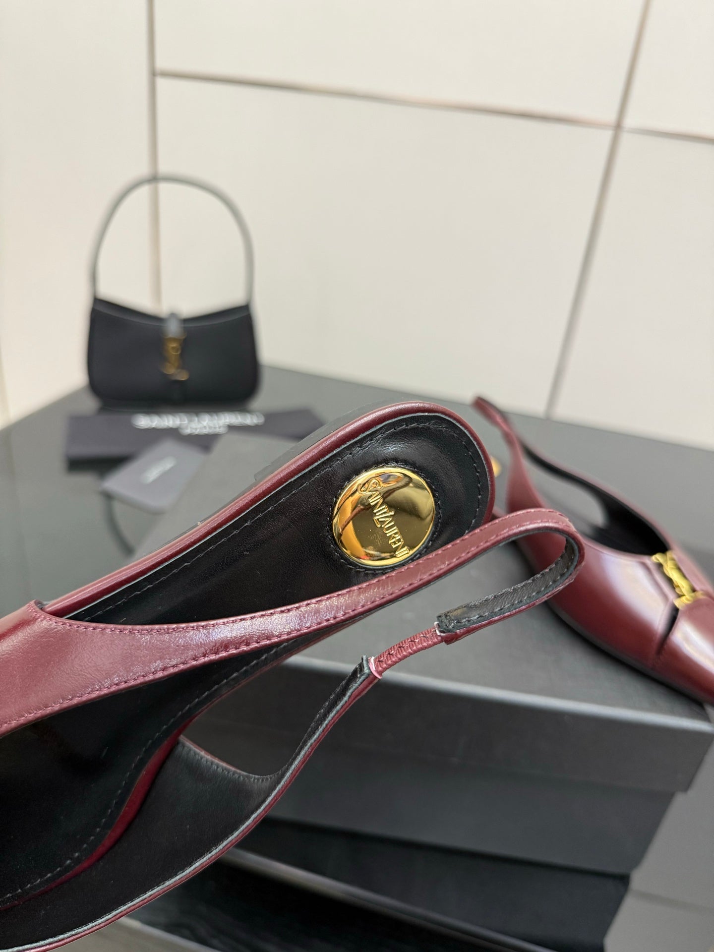 Women's YSL slingback flat, burgundy strap with gold emblem medallion detail