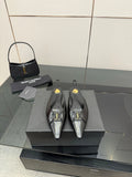 Black pointed-toe slingback heels with gold YSL hardware, shown as a pair on display