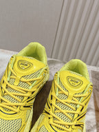 Dior unisex yellow sneakers with molded straps, mesh upper, and cushioned heel