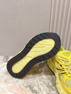 Dior unisex yellow sneakers with black-and-yellow outsole tread visible