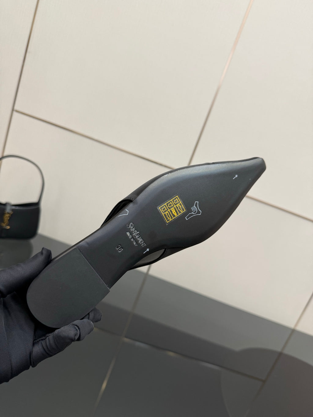 Women's black pointed-toe slingback heel insole with printed logo and lettering
