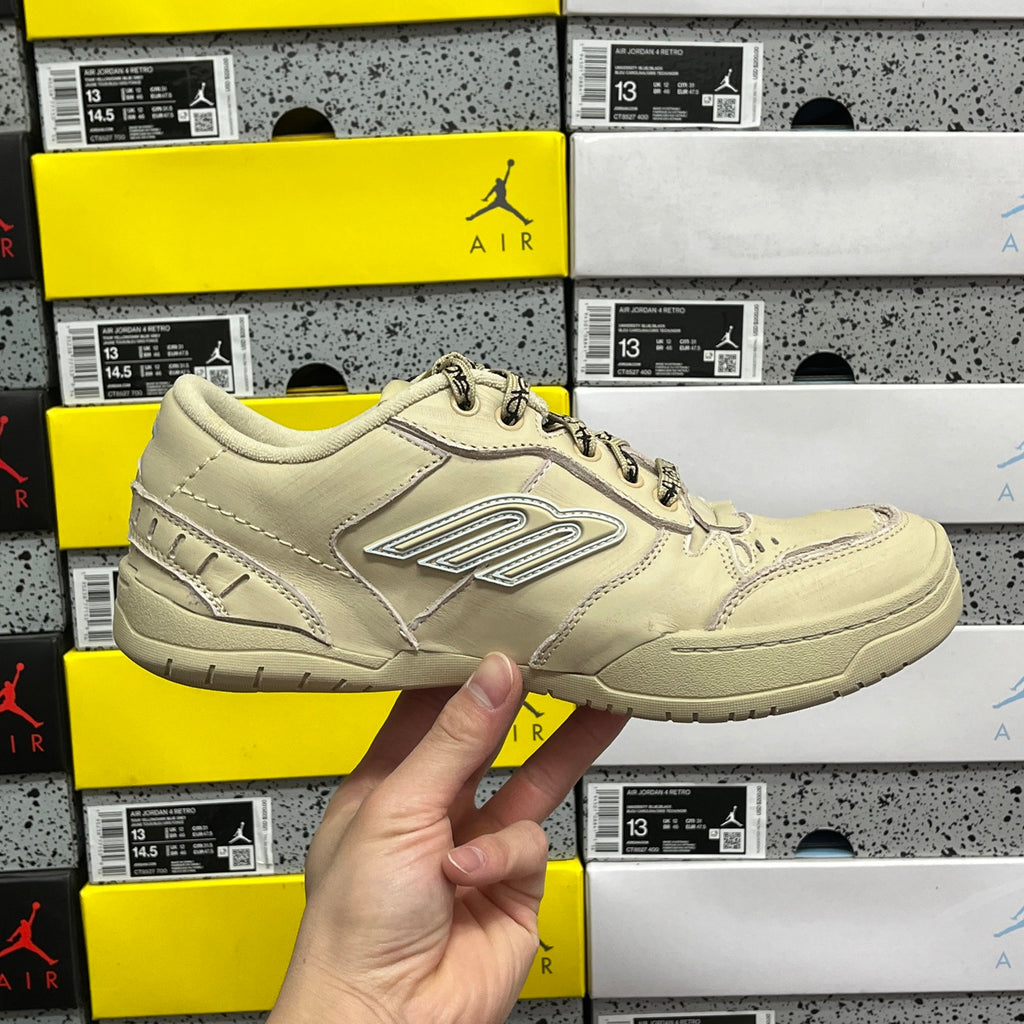 Beige Balenciaga low-top sneaker, angled side view with lace-up and logo