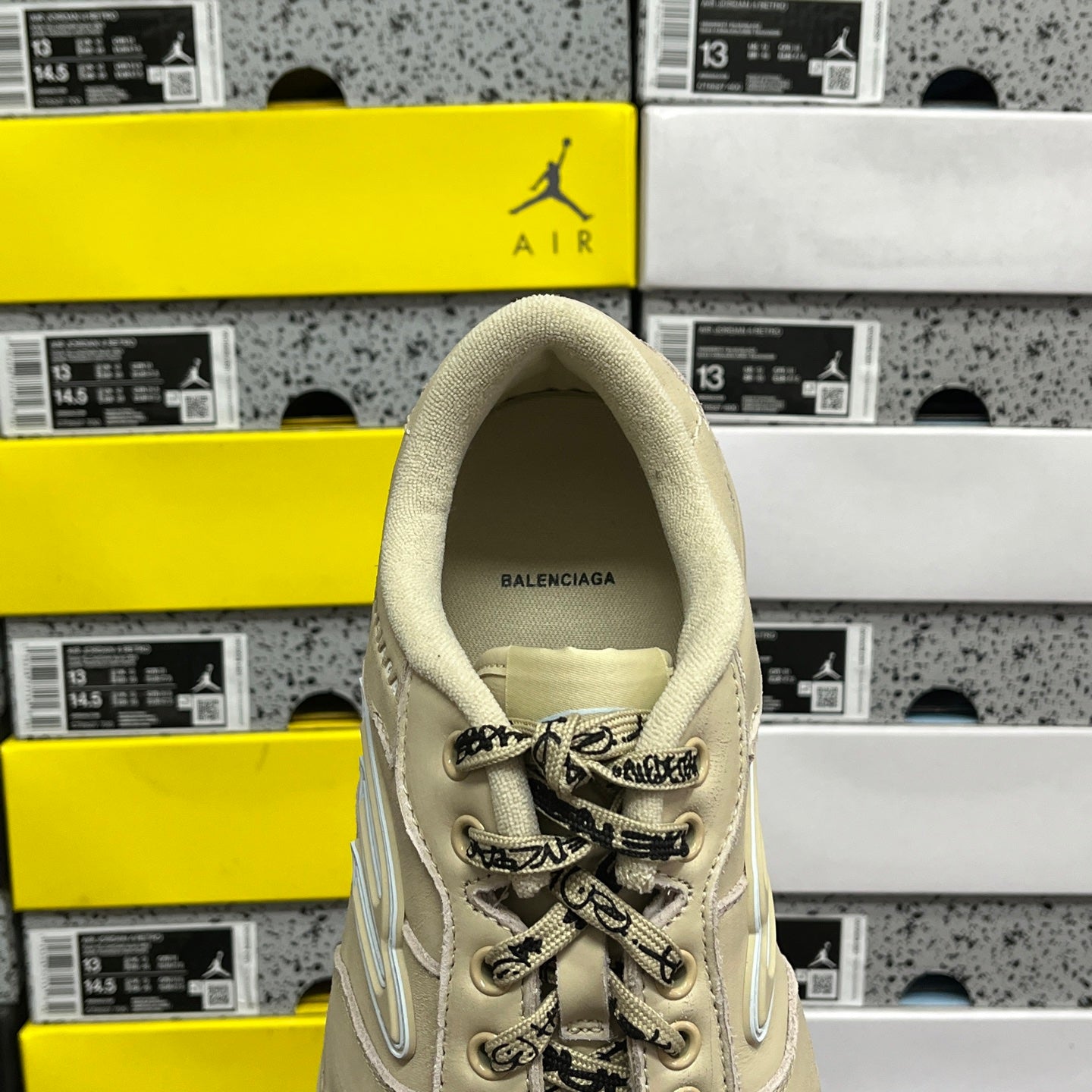 Beige Balenciaga sneaker with BALENCIAGA text on heel and lace-up upper