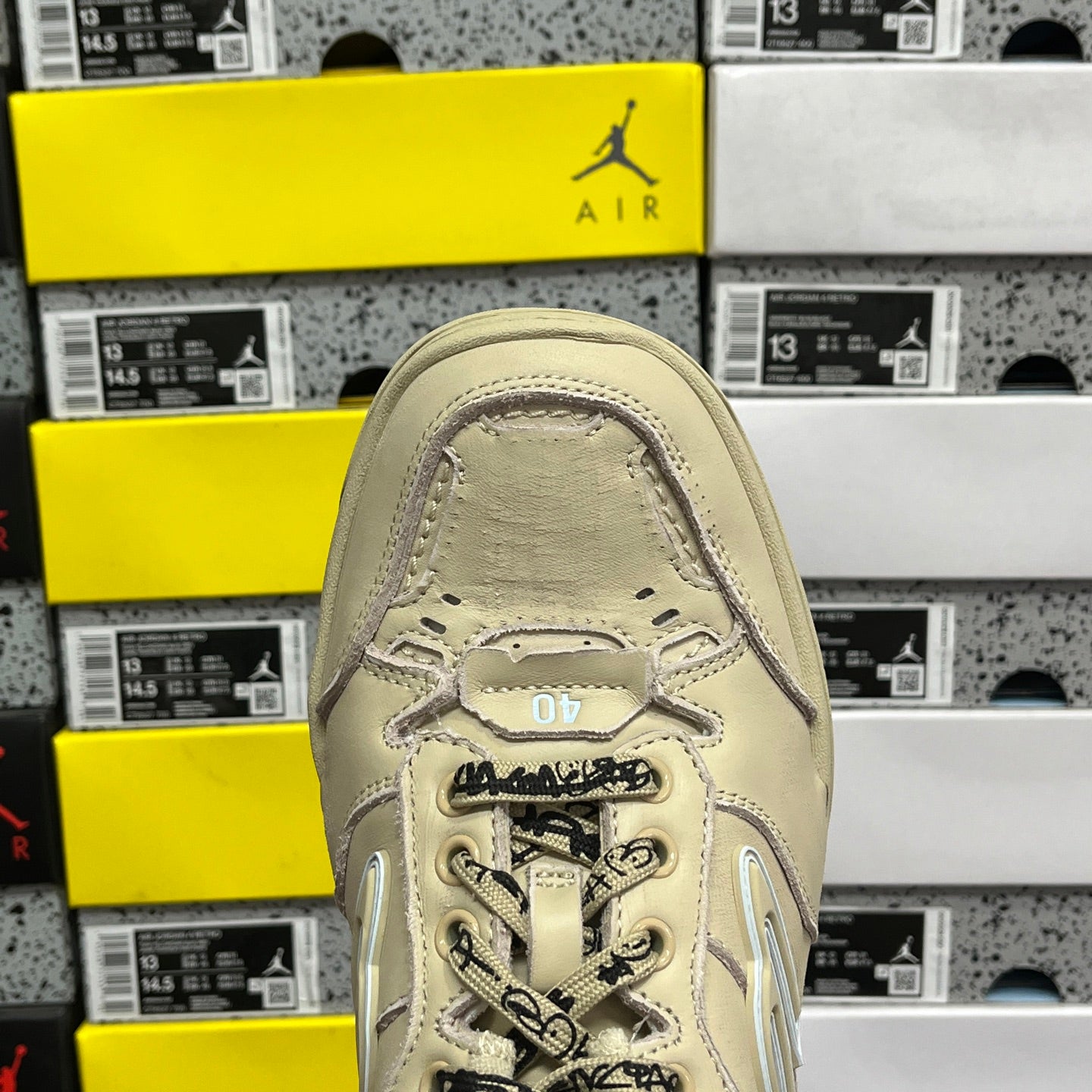 Beige Balenciaga sneaker toe cap with laces and BALENCIAGA text on collar