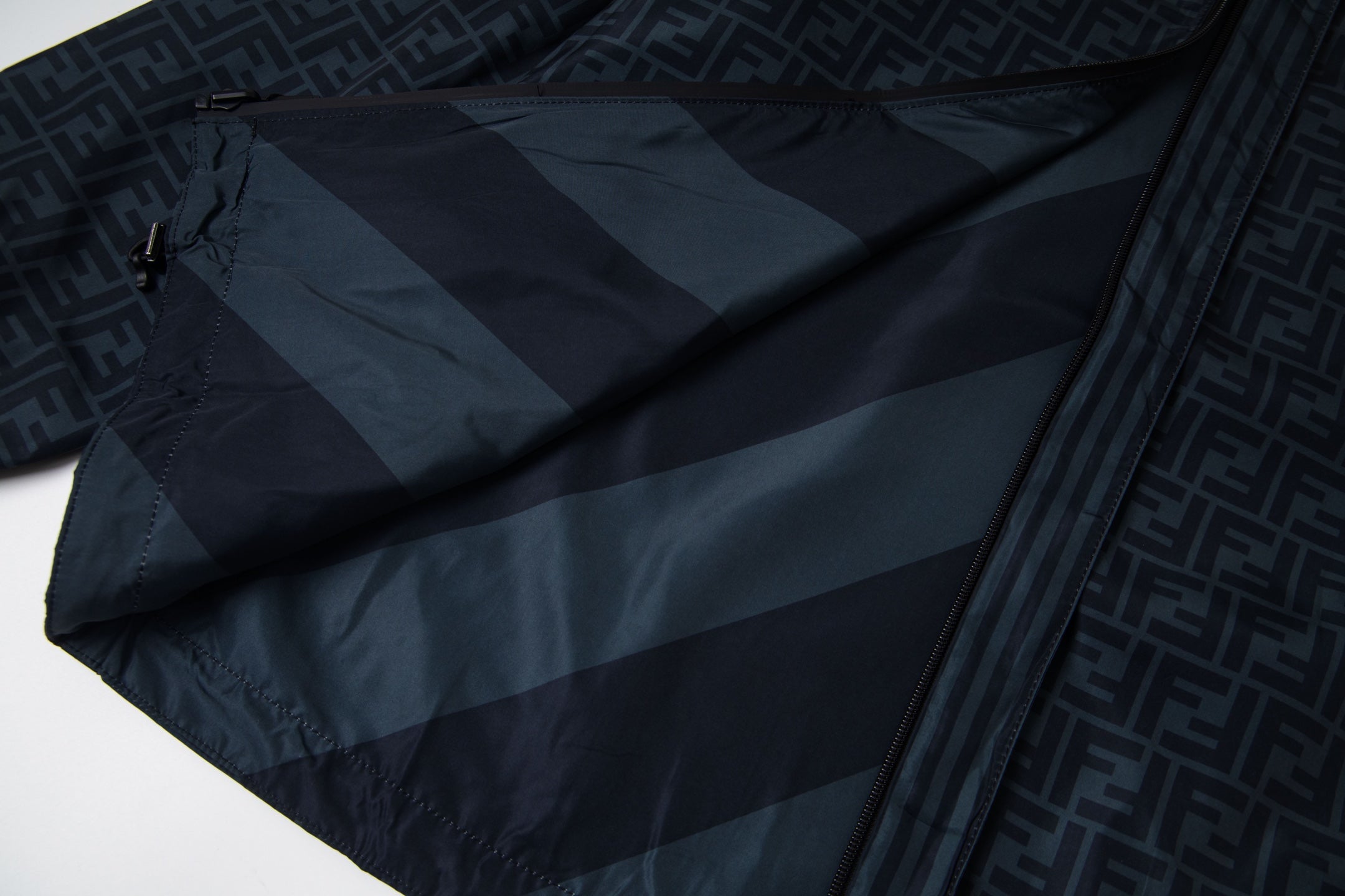 Fendi long hooded jacket fabric close-up in dark blue with diagonal stripe pattern