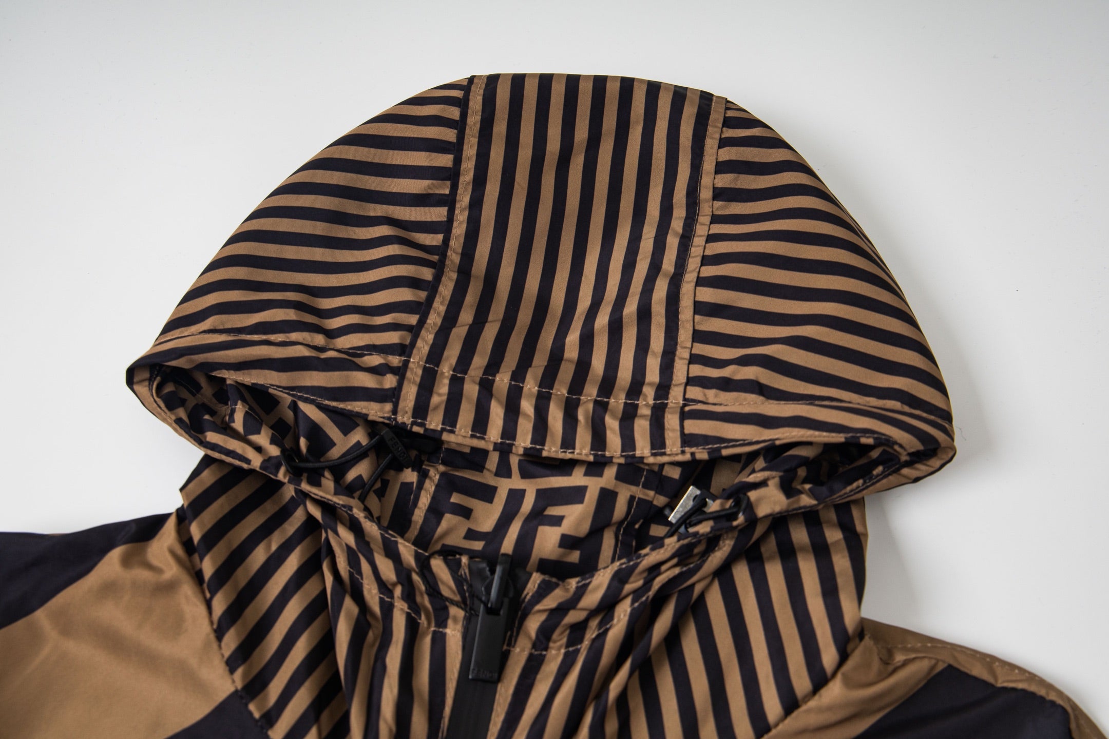 Fendi hood with tan and navy striped lining and gathered drawstring detail