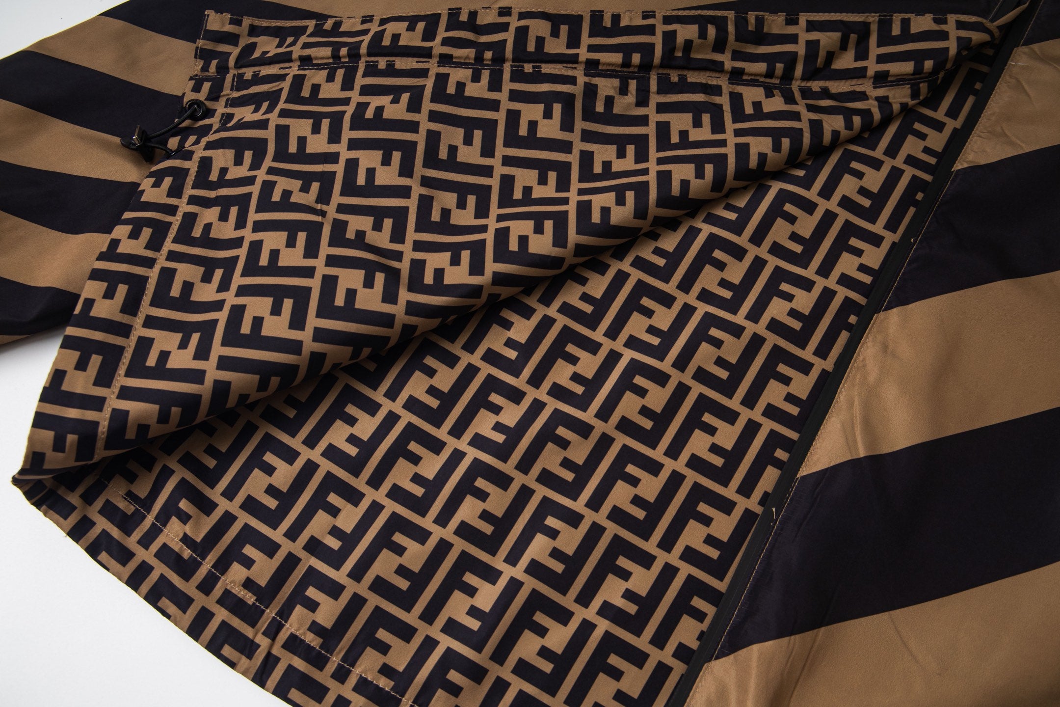 Fendi logo-pattern hood lining with diagonal tan and navy stripe outer panels