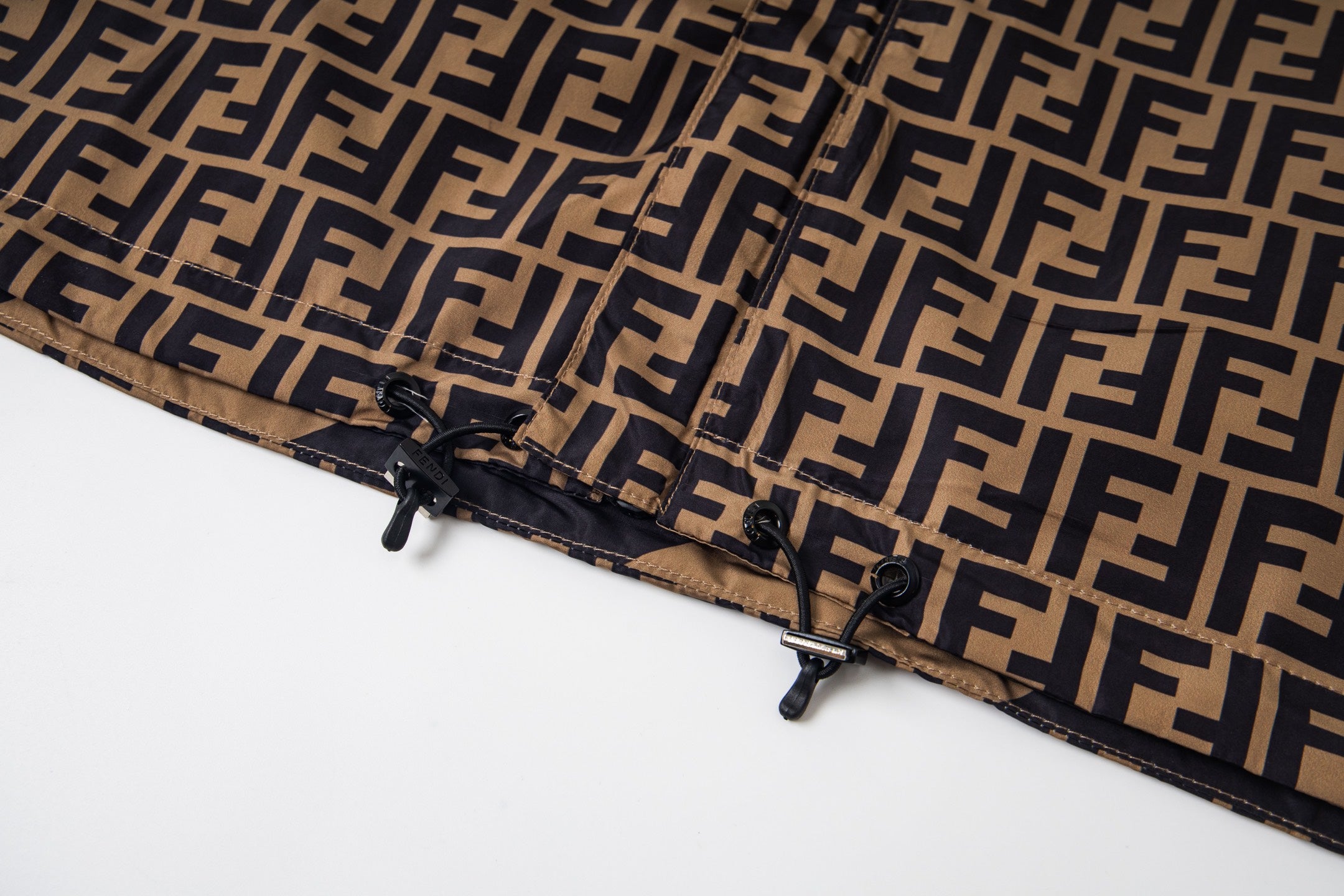 Fendi jacket hem with adjustable toggles over FF monogram fabric