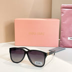 MiuMiu sunglasses with black frames and dark lenses
