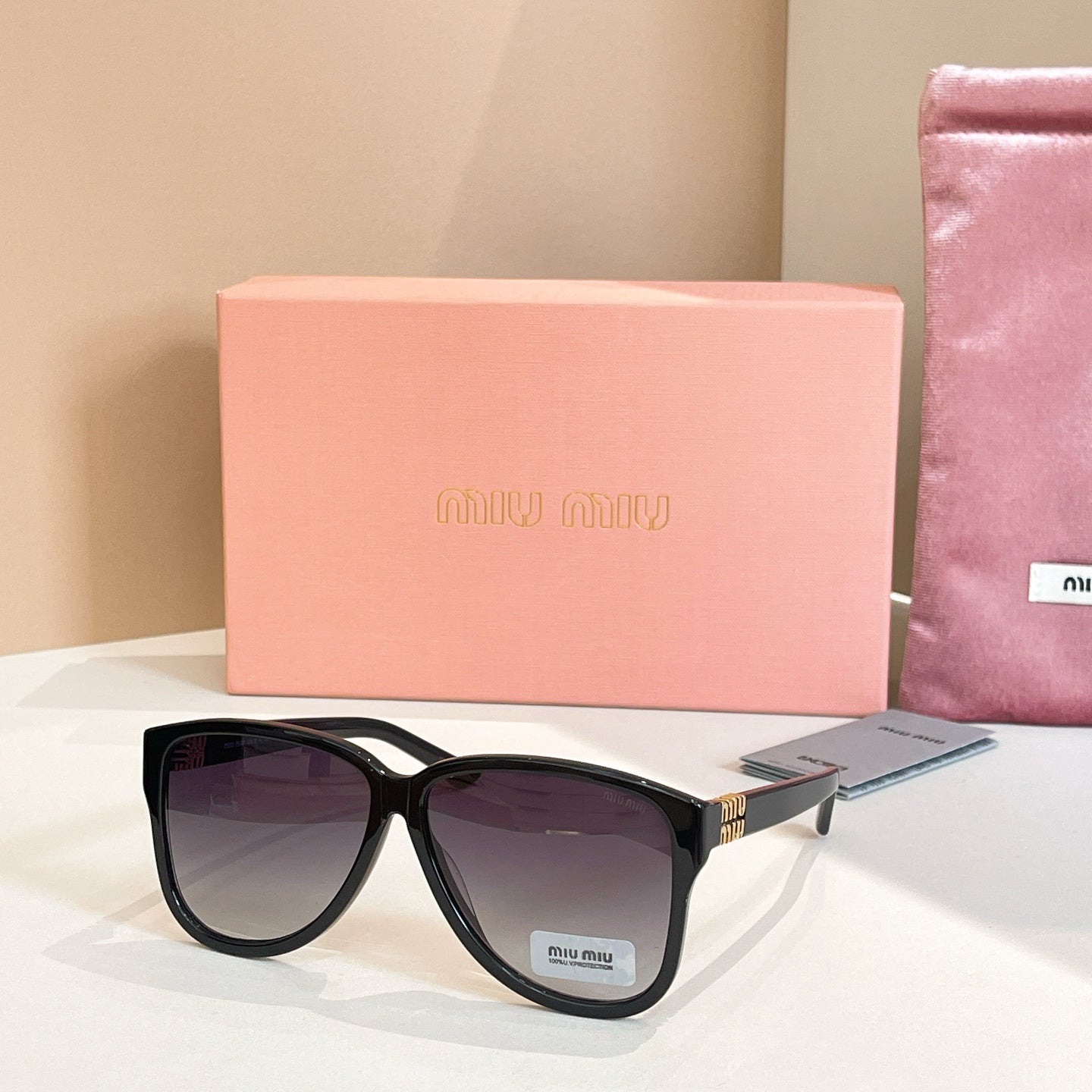 MiuMiu sunglasses with black frames and dark lenses