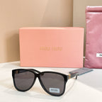 MiuMiu sunglasses with black frames and dark lenses
