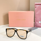 MiuMiu sunglasses with dark tortoiseshell frames and light lenses