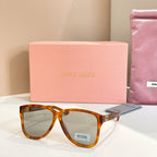 MiuMiu sunglasses with tortoiseshell frames and light lenses