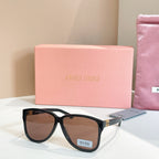 MiuMiu sunglasses with black frames and dark brown lenses