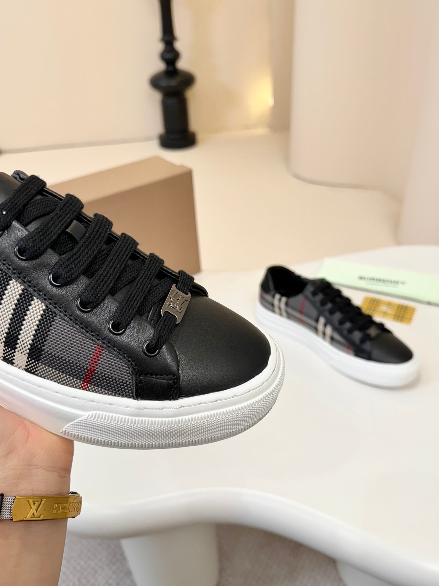 Burberry low-top sneakers, black leather with plaid trim and black lace eyelets