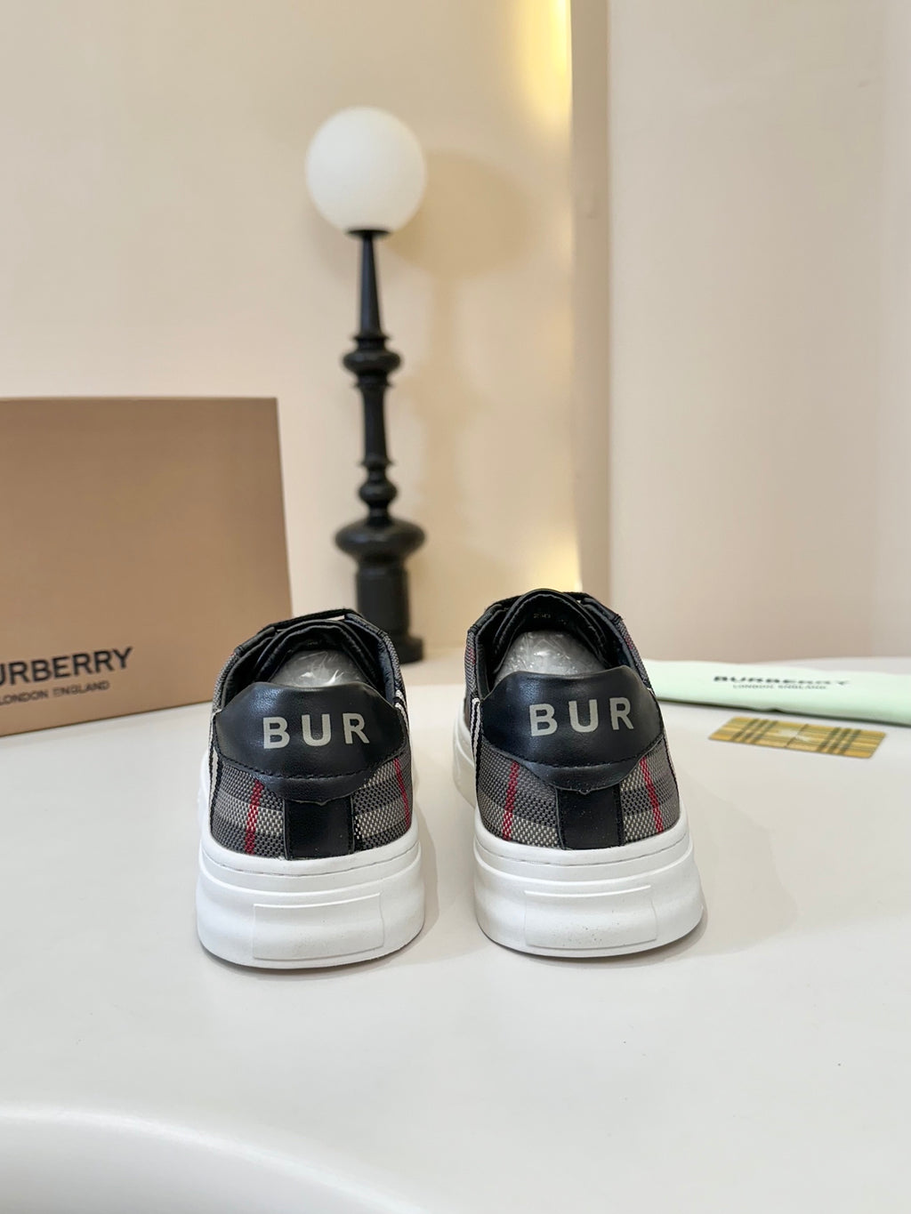 Burberry low-top sneakers back view, black heel with 'BUR' logo detail