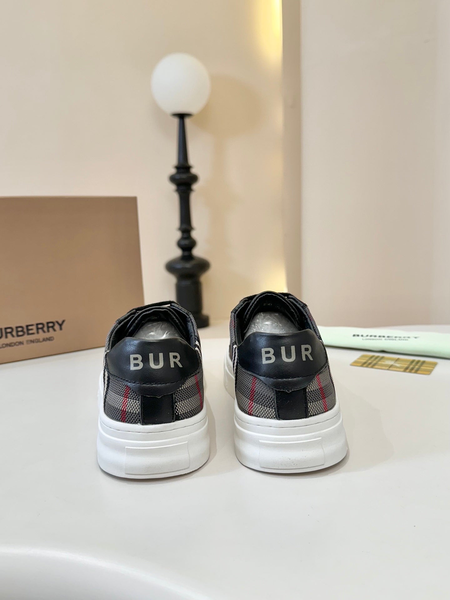 Burberry low-top sneakers back view, black heel with 'BUR' logo detail
