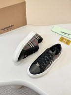 Burberry low-top sneakers, black leather toe with plaid side stripe and white sole