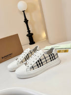 Low-top sneakers with white uppers and black-and-cream check side panels
