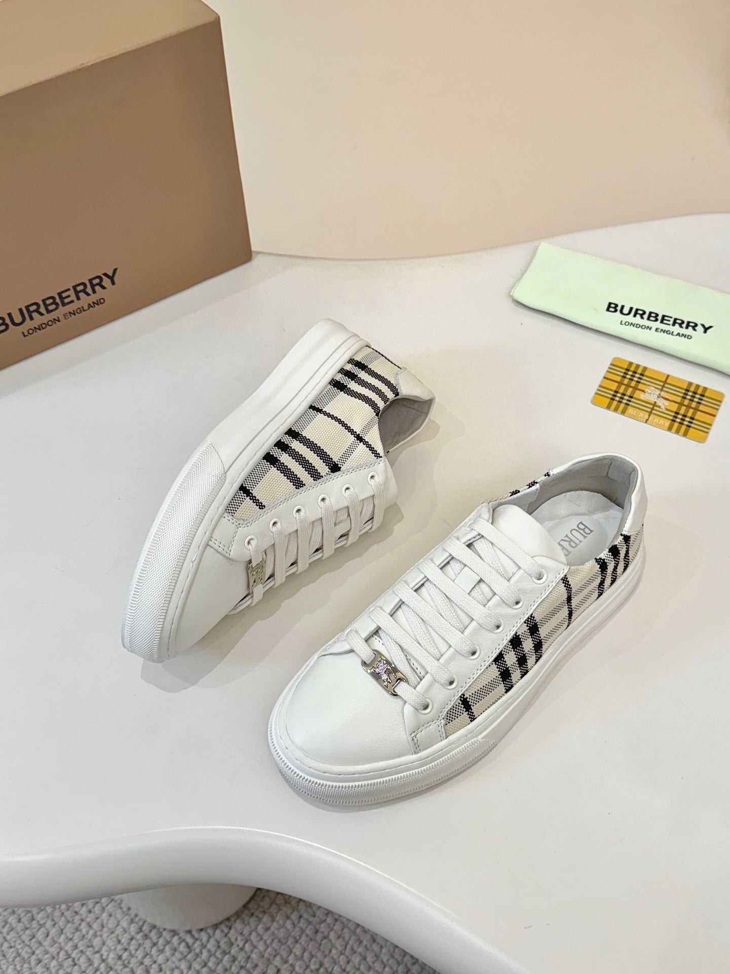 Low-top sneakers with white leather and black-and-cream check trim