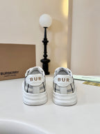 Back view of check-panel low-top sneakers with white heel tabs and striped collars