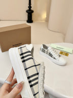 Side view of check-panel low-top sneakers in white with lace-up detail