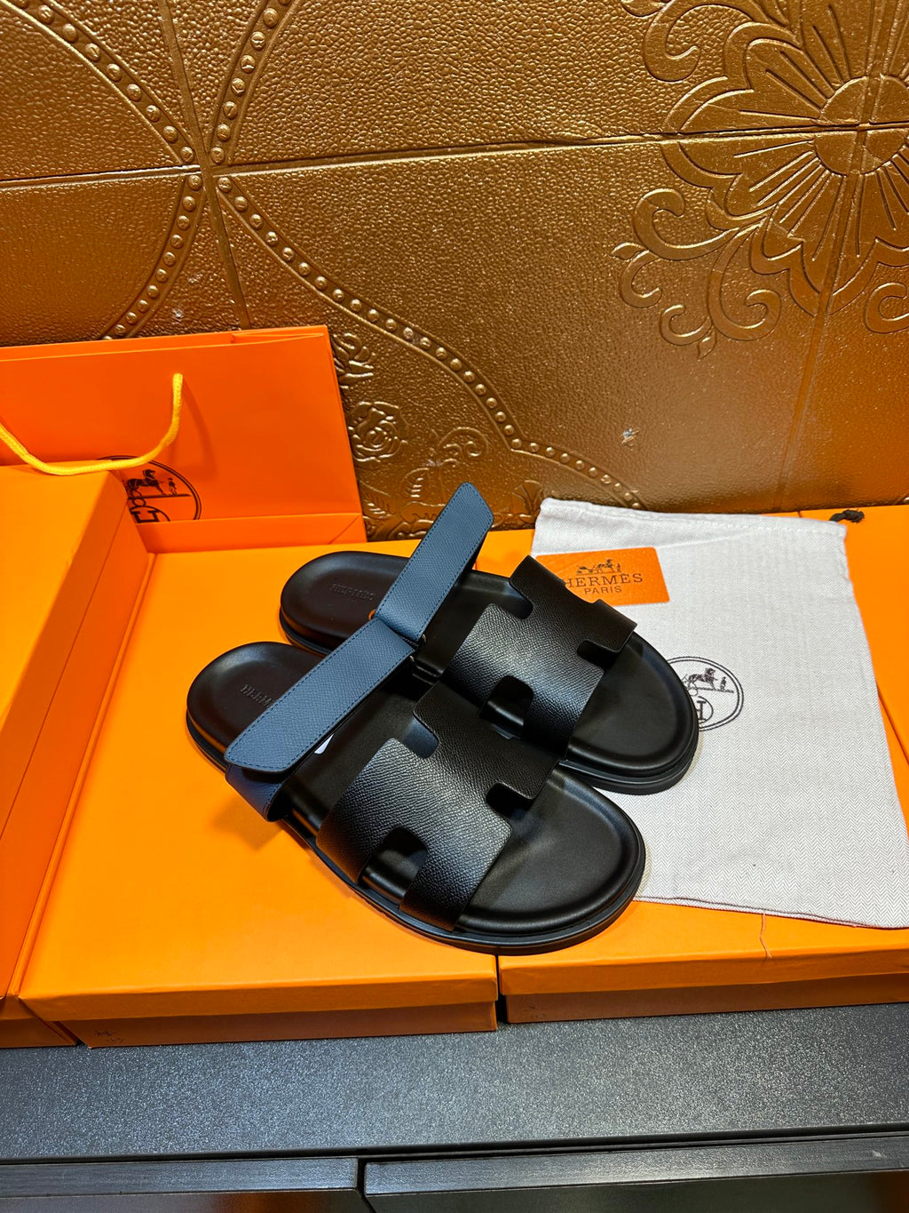 Hermes black slide sandals with blue top strap, cushioned footbed