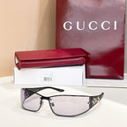 Black sunglasses with gold logo accents on the temples