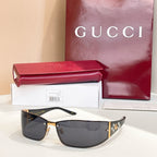 Black sunglasses with dark lenses and gold crest on temple