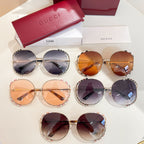 Assorted Gucci round sunglasses with tinted lenses and mixed gold and patterned frames