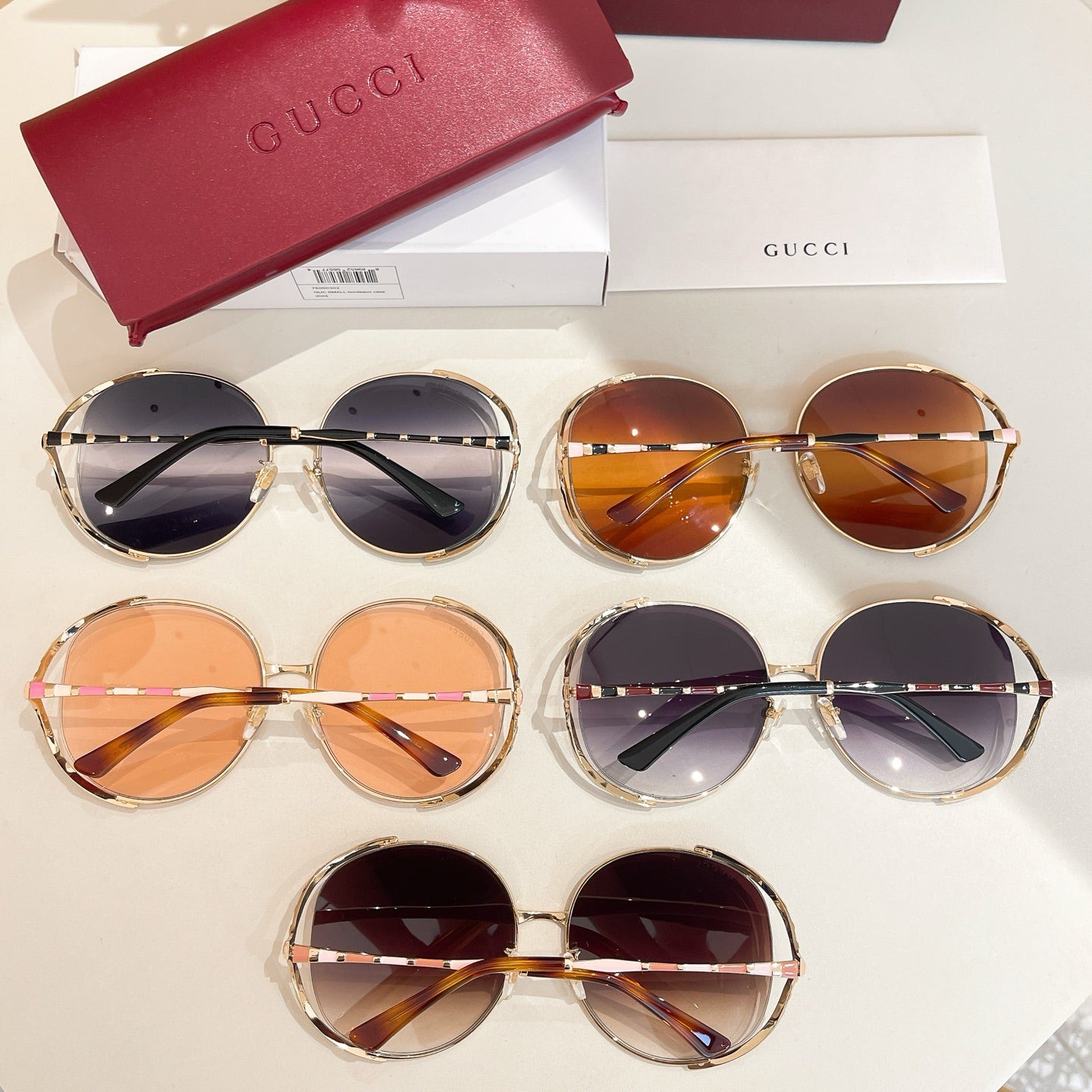Set of Gucci round sunglasses with tinted lenses, gold frames, and patterned details