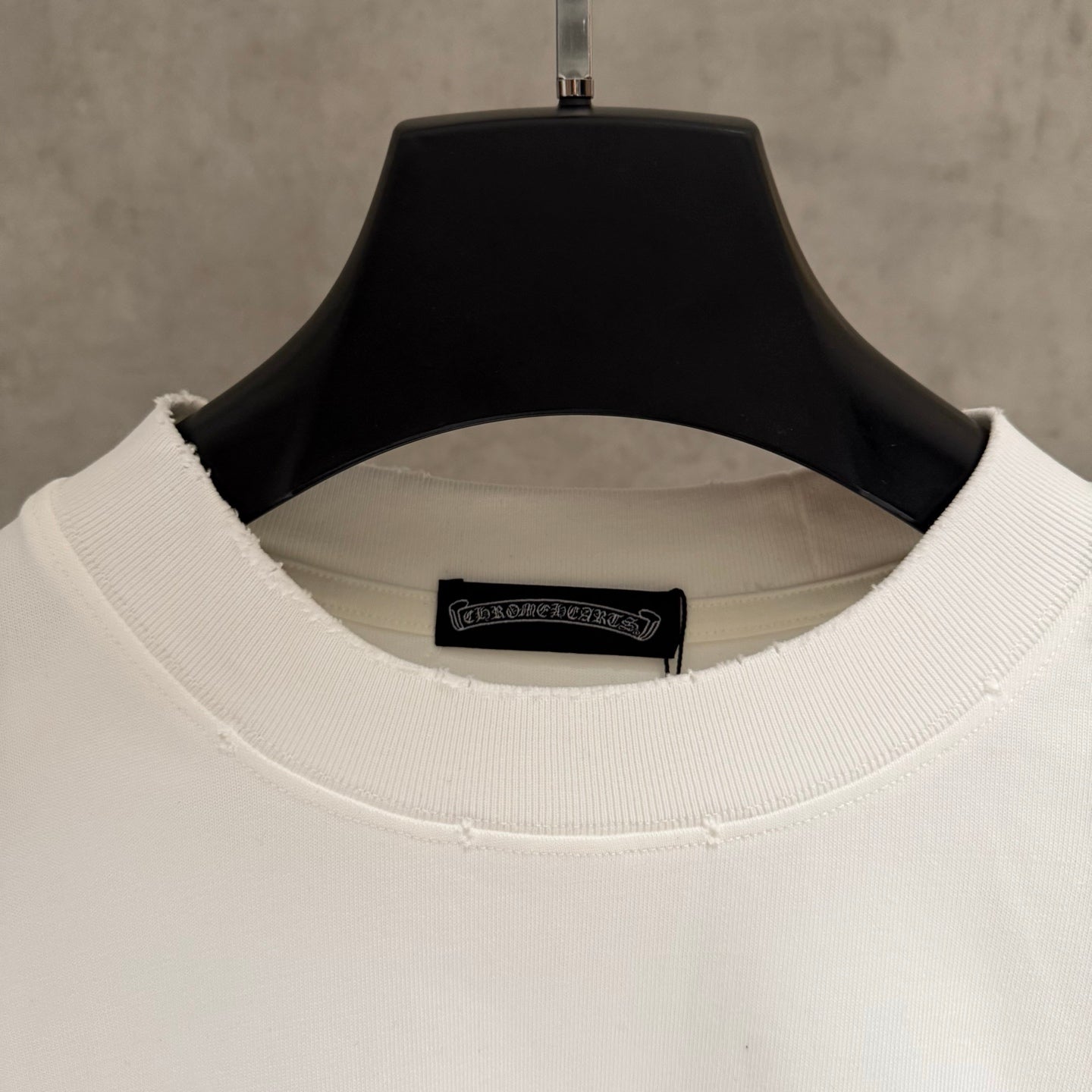 White crew-neck T-shirt with ribbed collar and inner brand label