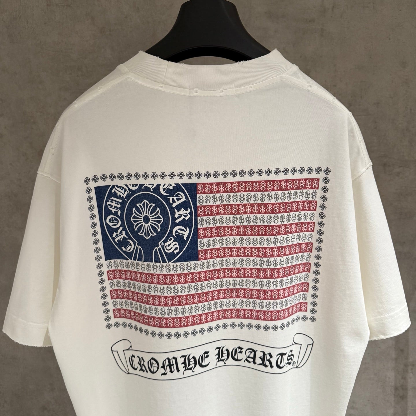 White short-sleeve T-shirt with large back patriotic print and “Chrome Hearts” text