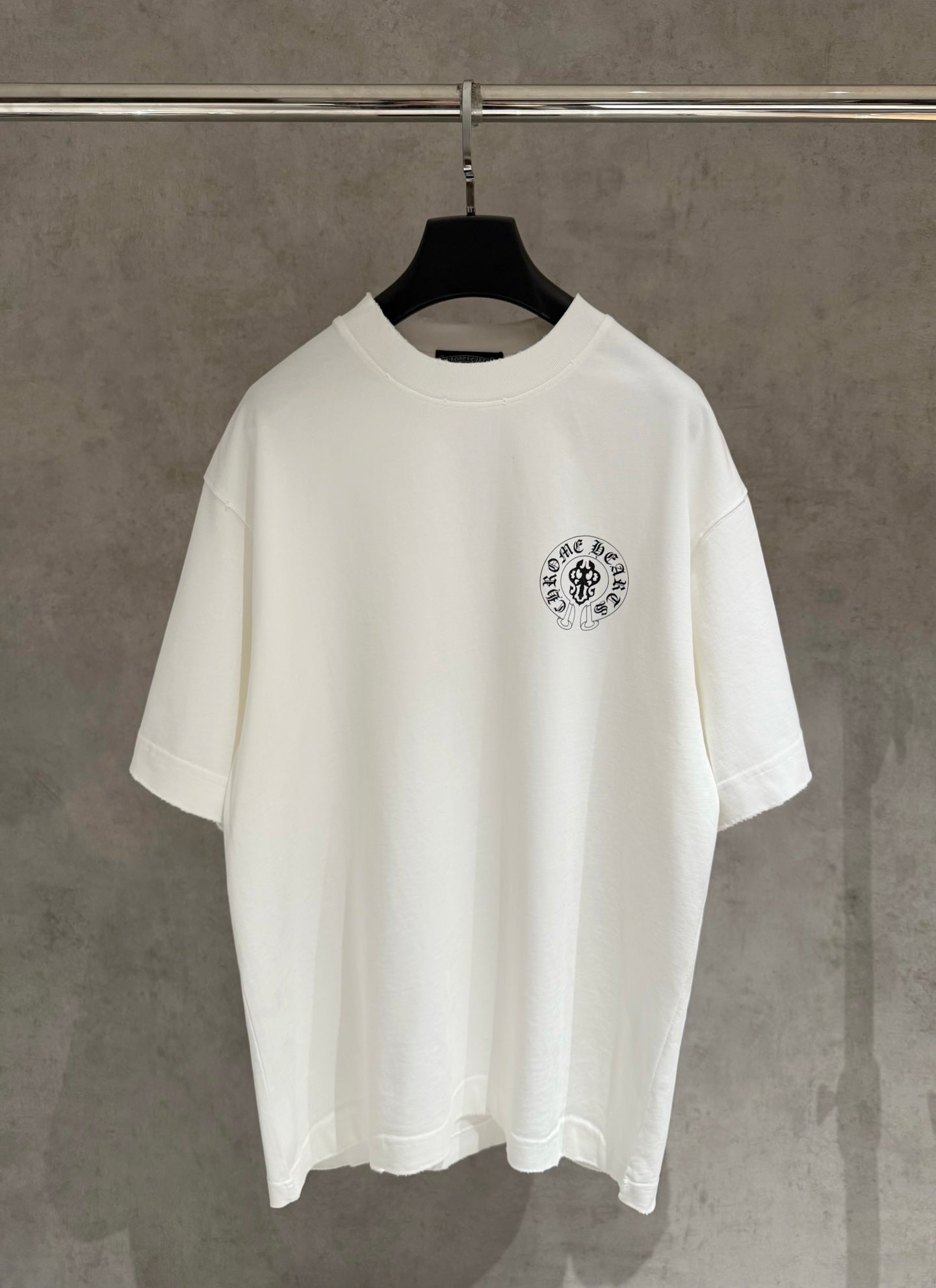 White short-sleeve T-shirt with small circular chest logo