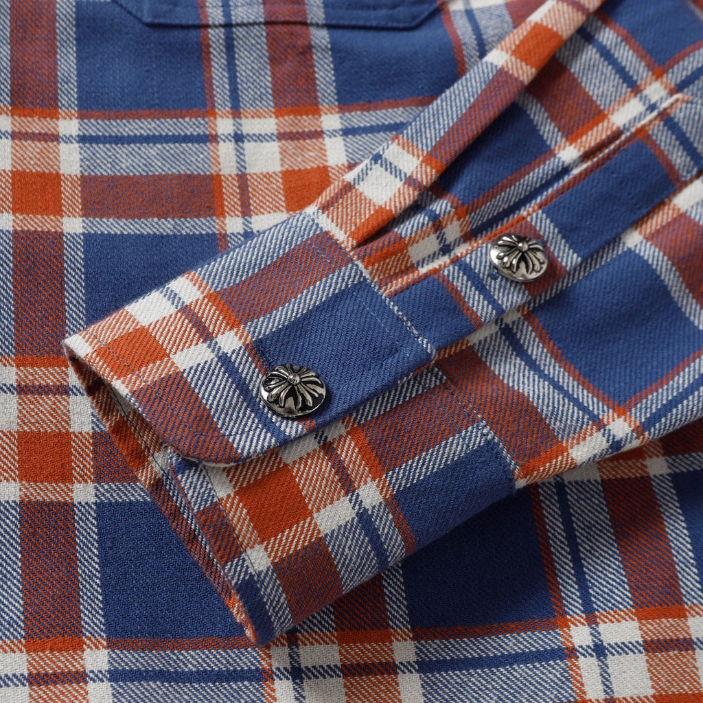 Plaid shirt cuffs with button closures and contrast trim.