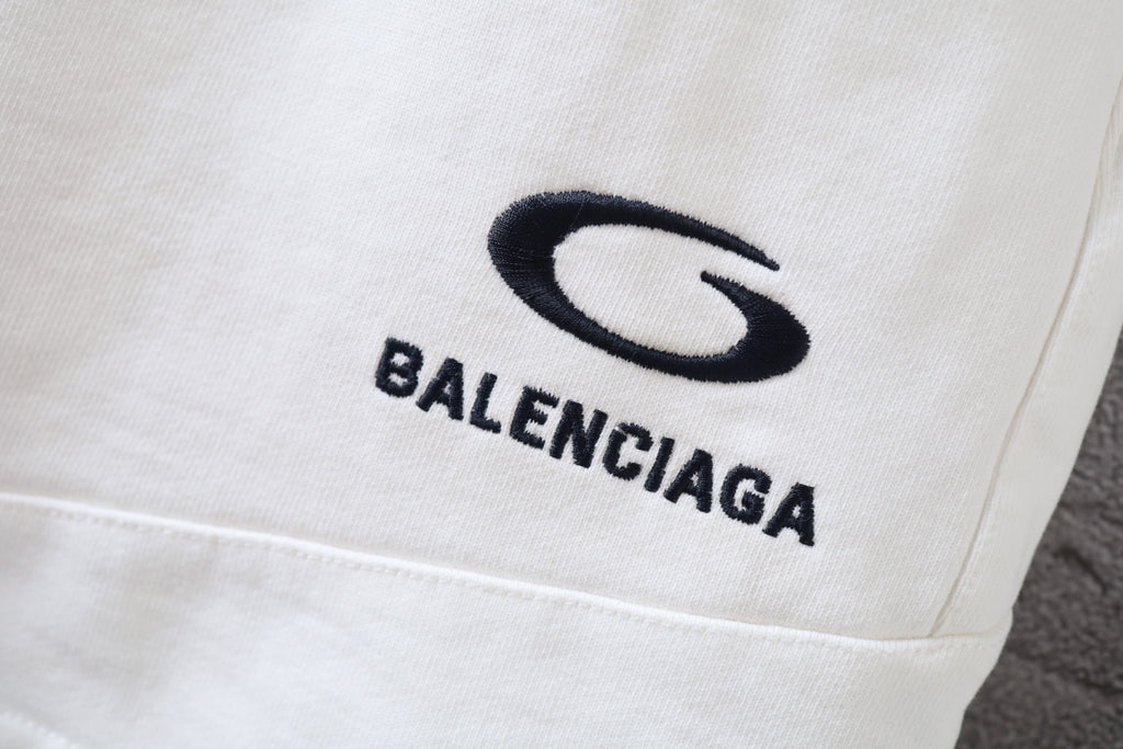 White shorts fabric close-up with Balenciaga logo on the front leg