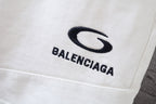 White shorts fabric close-up with Balenciaga logo on the front leg