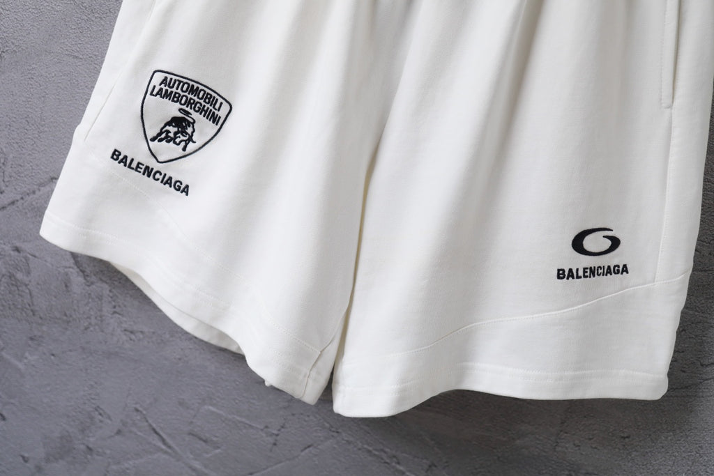 White shorts side view with circular Balenciaga logo print and hem