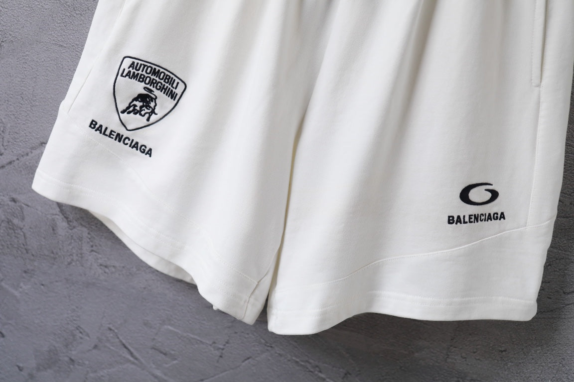 White shorts side view with circular Balenciaga logo print and hem