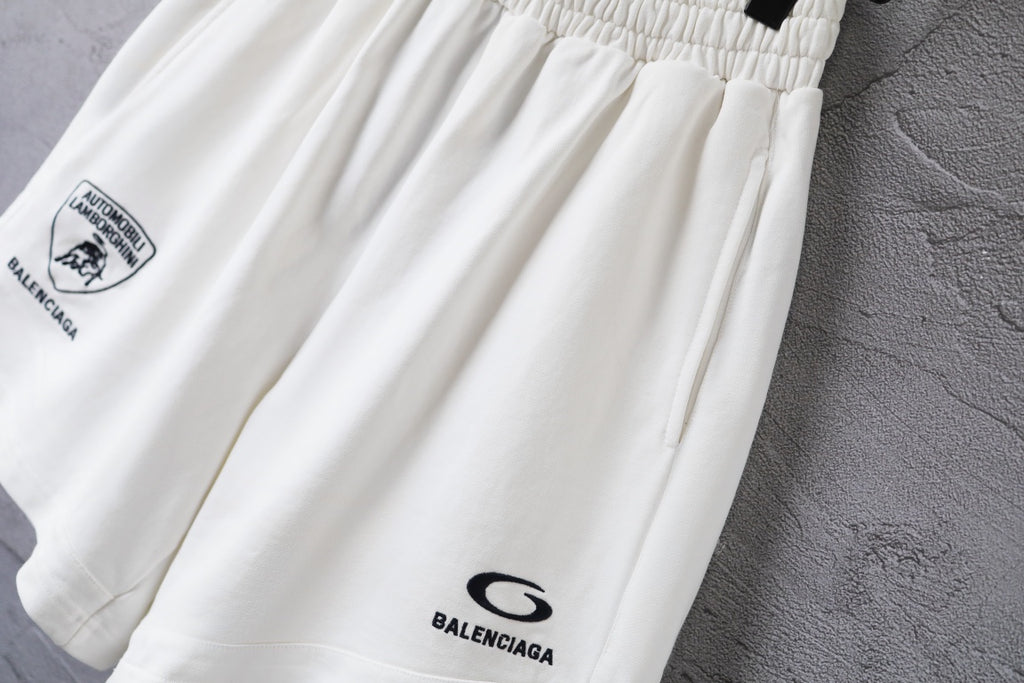 White shorts close-up of gathered waist and small Balenciaga logo at leg