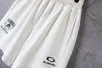White shorts close-up of gathered waist and small Balenciaga logo at leg