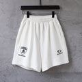 White drawstring shorts with elastic waistband and front Balenciaga logo patch